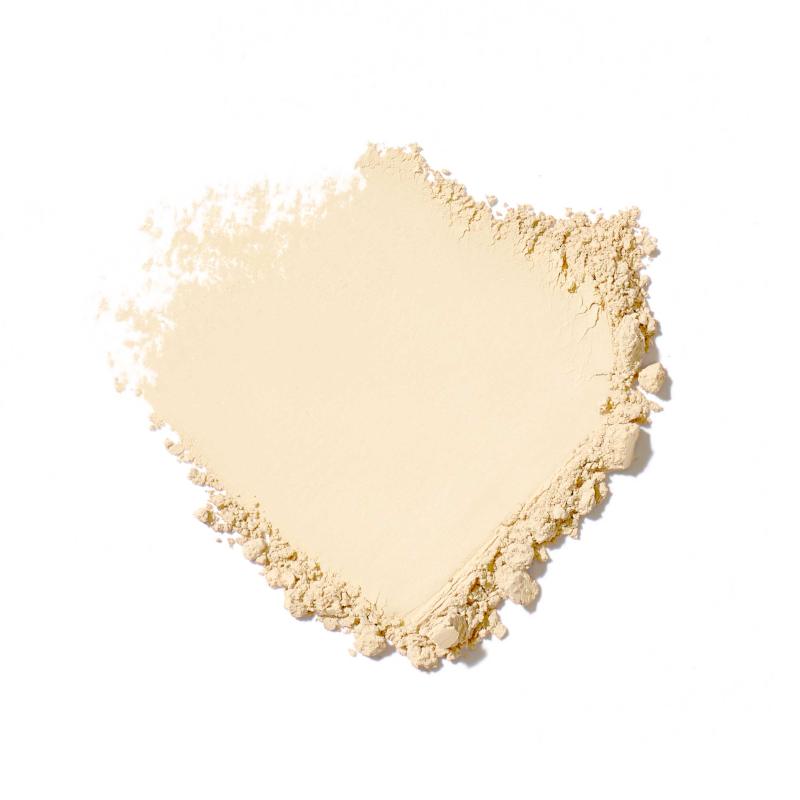 Heart-shaped pile of light beige powder on a white background