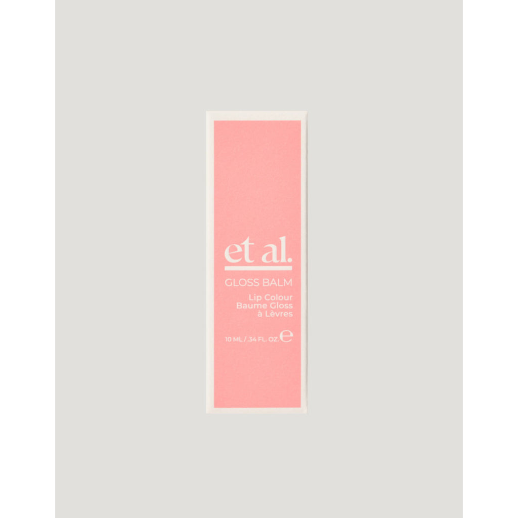 Pink lip balm packaging with 'et al.' branding on a light gray background