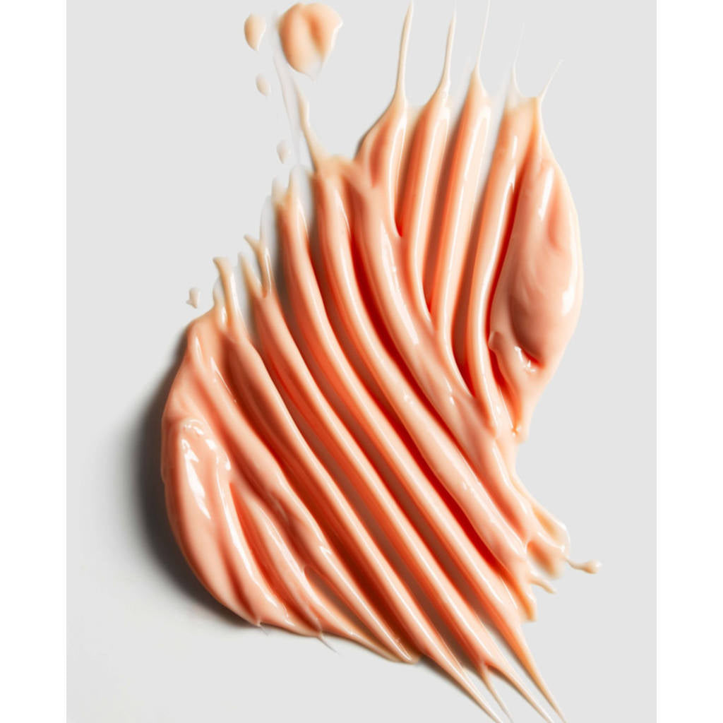 Pink cream or makeup swatch on a light gray background