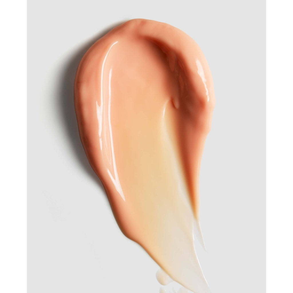 Close-up of a smooth, beige-colored cosmetic product on a light gray background