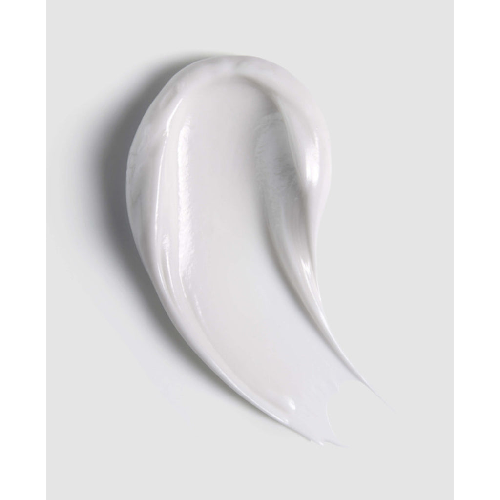 Close-up of a smooth, white cream on a light gray background