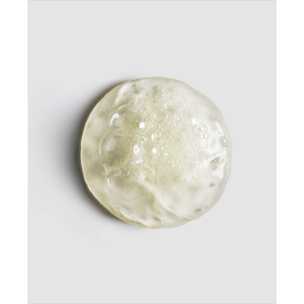 Clear glass sphere with bubble texture on a light gray background