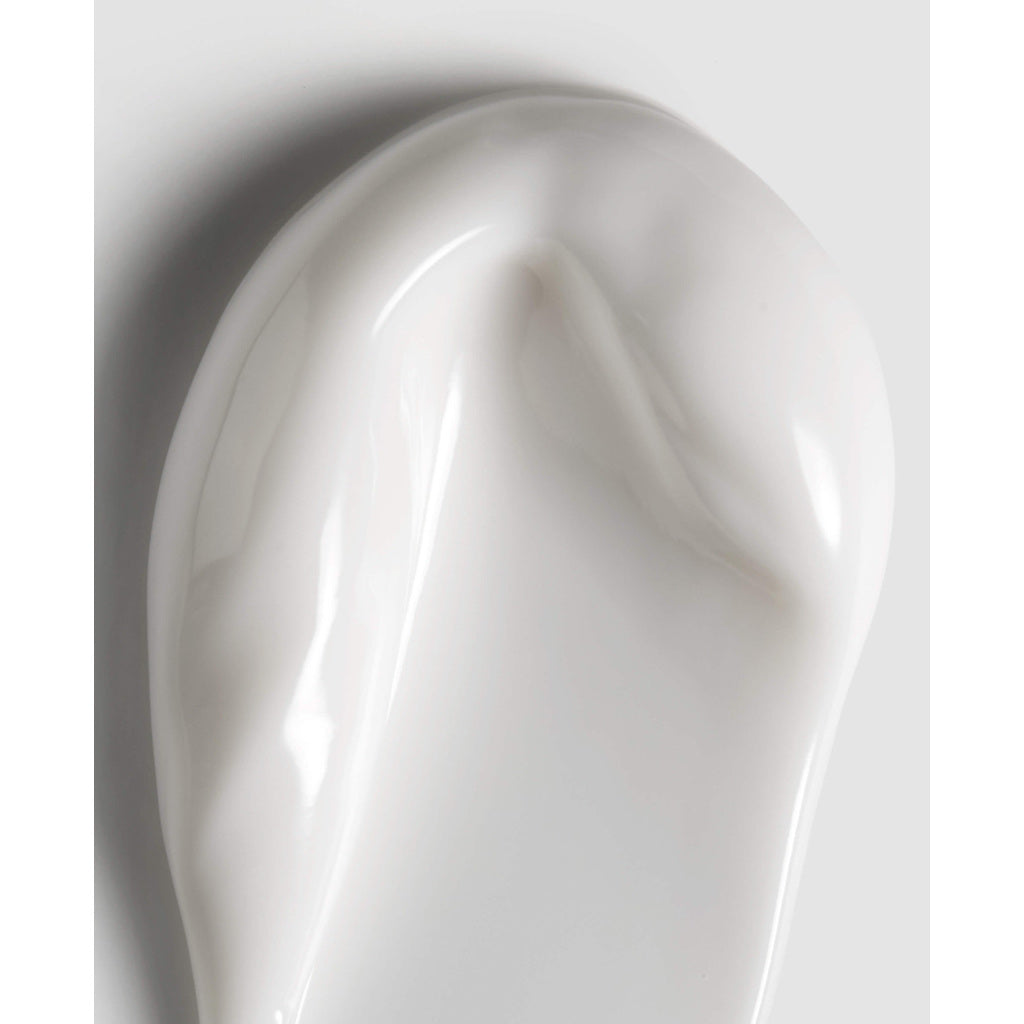 Close-up of a smooth, white ceramic vase on a light gray background