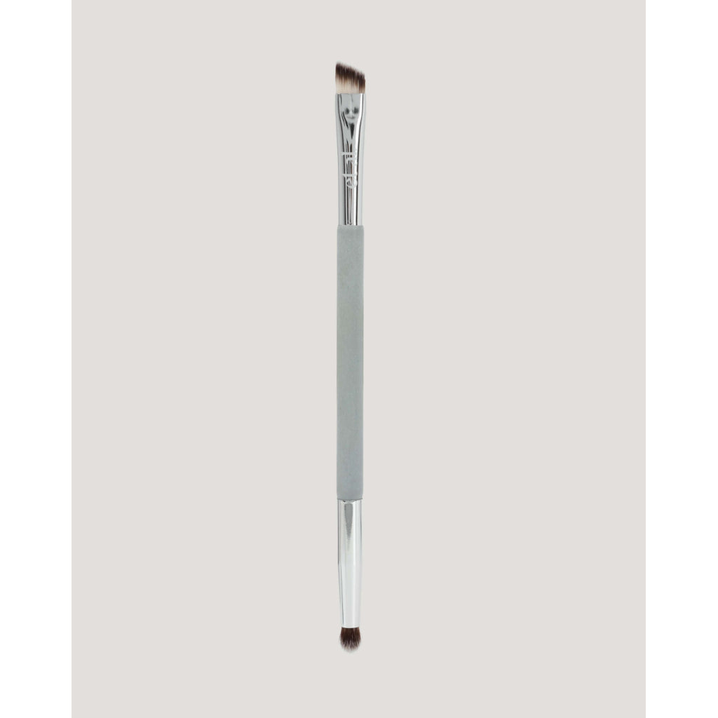 Eyebrow brush with a gray handle on a light gray background