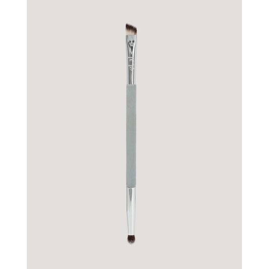 Eyebrow brush with a gray handle on a light gray background