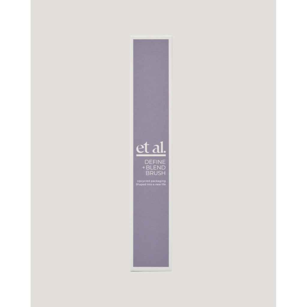 Purple makeup brush packaging with 'et al.' branding on a light gray background