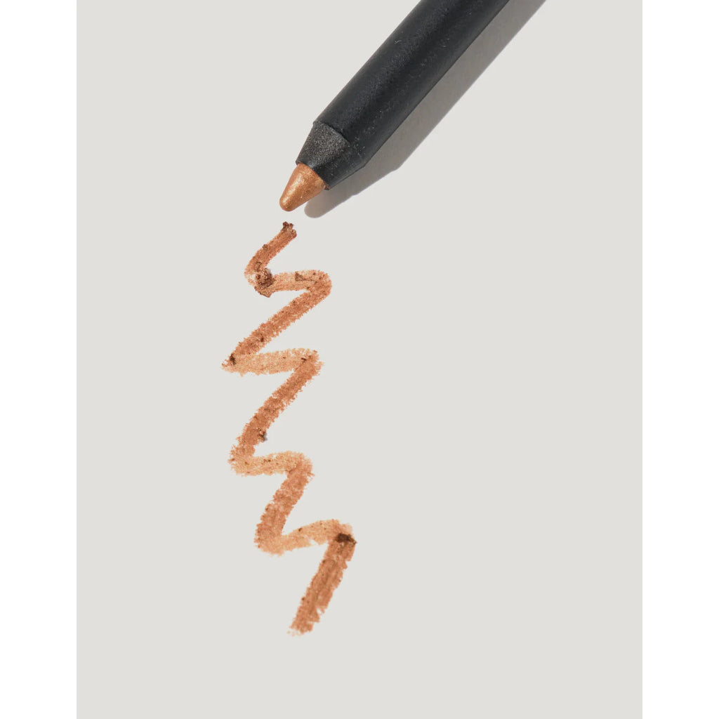Makeup pencil with a wavy line of color on a light gray background