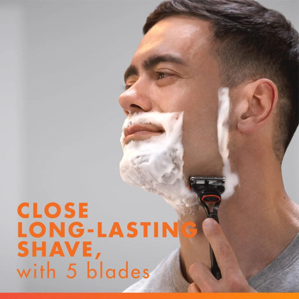 Man shaving with a razor and foam, text about close long-lasting shave with 5 blades.