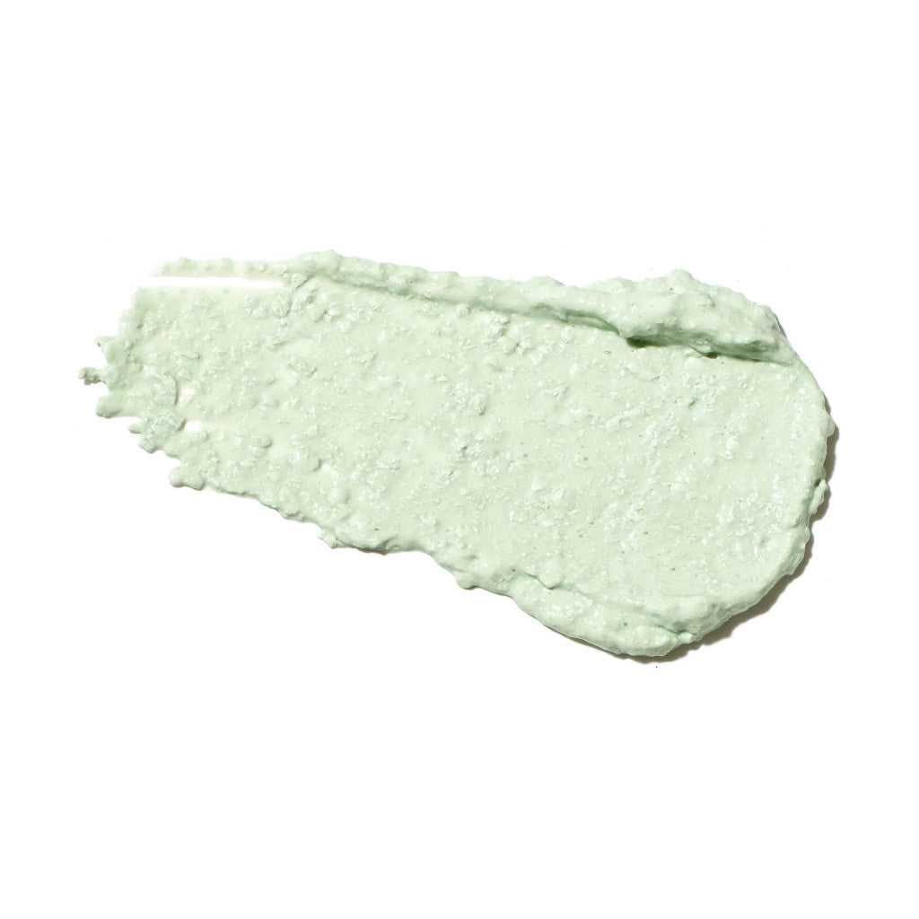 Green smear of cream or makeup on a white background