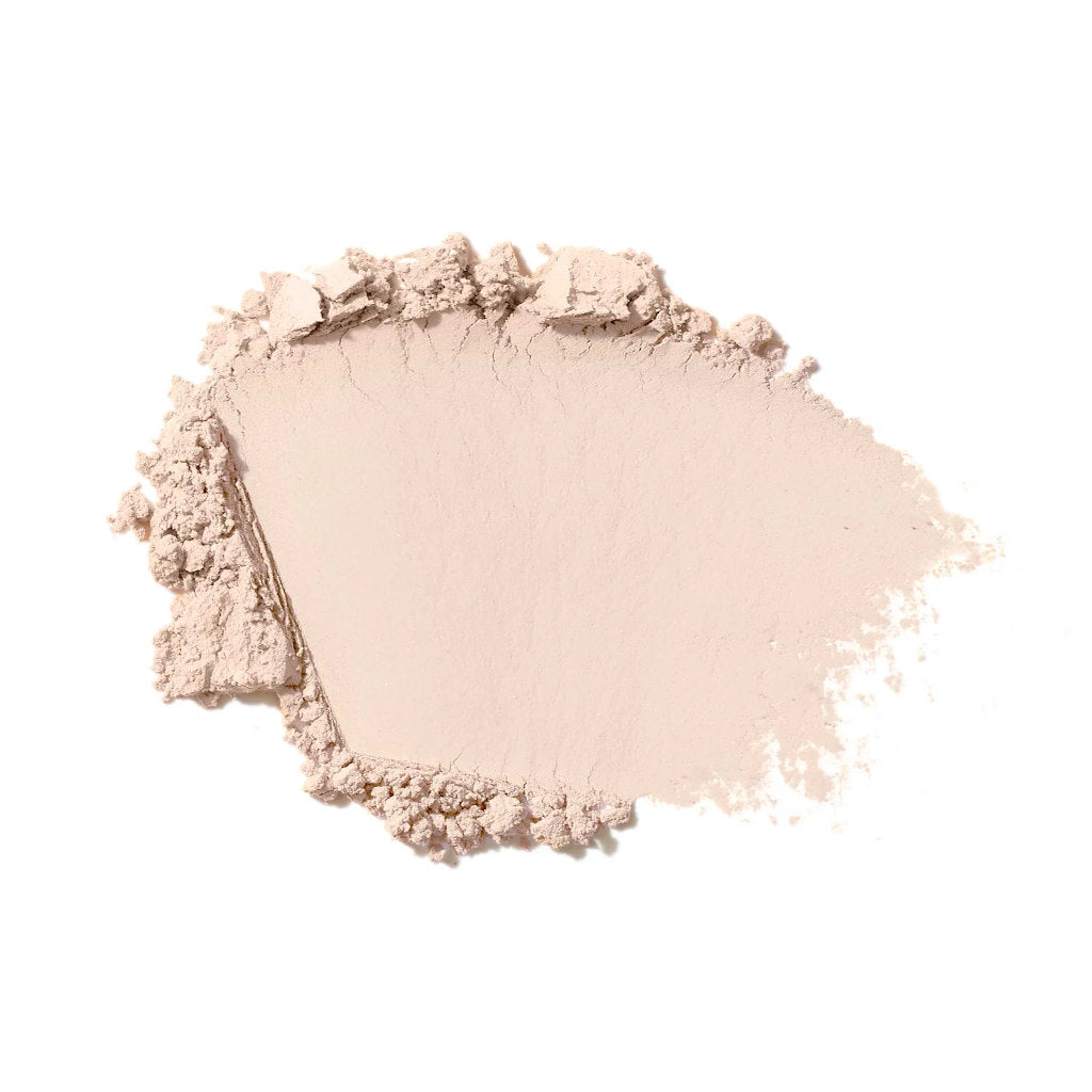 Ivory shade makeup powder on a white background