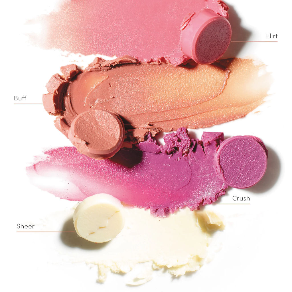 Close-up of different shades of pink makeup products with labels on a white background