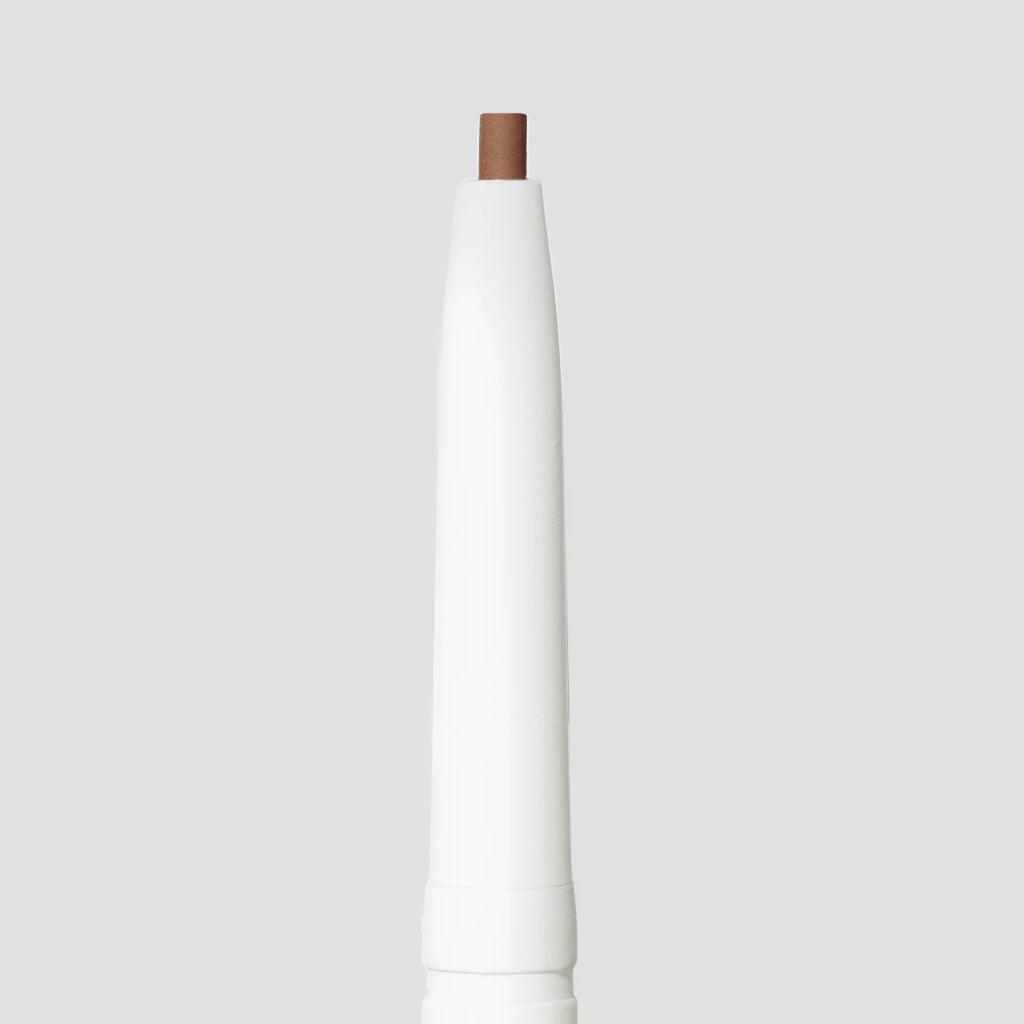 White cylindrical object with a brown top on a light gray background