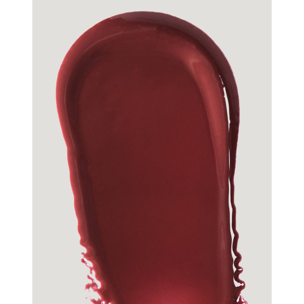 Red lipstick swatch on a light gray background